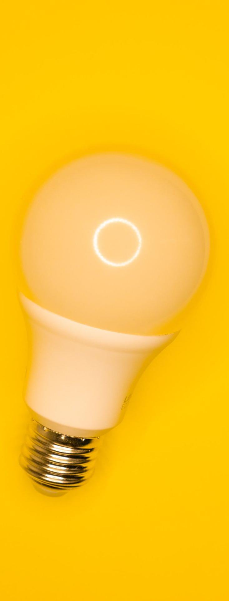 white light bulb on yellow surface